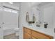 This bathroom includes a shower-tub combo and a vanity with modern fixtures and a wood-grain cabinet at 9047 Harbor Wind Ave, Las Vegas, NV 89178