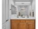 Bathroom vanity featuring double sinks, a large mirror, and ample counter space at 9047 Harbor Wind Ave, Las Vegas, NV 89178