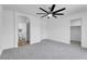 Bedroom with ceiling fan, carpet, neutral walls, and connected bathroom and closet at 9047 Harbor Wind Ave, Las Vegas, NV 89178
