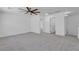 This spacious carpeted bonus room has neutral paint, modern ceiling fan, and recessed lighting with several entryways at 9047 Harbor Wind Ave, Las Vegas, NV 89178