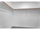 Walk-in closet with white walls, carpet flooring, and built-in wooden clothing rods at 9047 Harbor Wind Ave, Las Vegas, NV 89178