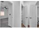 Bright hallway featuring carpet and a doorway to a bedroom with a ceiling fan at 9047 Harbor Wind Ave, Las Vegas, NV 89178