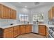Updated kitchen featuring wood cabinets, stainless steel appliances, and natural light at 9047 Harbor Wind Ave, Las Vegas, NV 89178