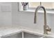 Modern kitchen sink with stainless steel faucet and subway tile backsplash at 9047 Harbor Wind Ave, Las Vegas, NV 89178