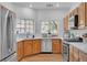 Bright kitchen features stainless steel appliances, granite countertops and wood flooring at 9047 Harbor Wind Ave, Las Vegas, NV 89178