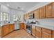 Bright kitchen features stainless steel appliances, granite countertops and wood flooring at 9047 Harbor Wind Ave, Las Vegas, NV 89178