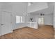 Spacious living room with wood floors, chandelier, and lots of natural light at 9047 Harbor Wind Ave, Las Vegas, NV 89178