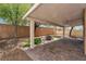 Covered patio area with pavers, trees, and partial brick wall at 9047 Harbor Wind Ave, Las Vegas, NV 89178