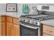 Close up of the stainless steel stove and oven with granite countertops at 9047 Harbor Wind Ave, Las Vegas, NV 89178