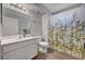 Bright bathroom featuring a white vanity, toilet, and shower with bamboo-themed curtain at 9070 Spring Mountain Rd # 114, Las Vegas, NV 89117