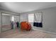 Bedroom featuring modern gray walls, wood flooring, and closet with mirrored doors at 9070 Spring Mountain Rd # 114, Las Vegas, NV 89117
