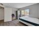 Bedroom featuring modern gray walls, wood flooring, window, a bed and closet for storage at 9070 Spring Mountain Rd # 114, Las Vegas, NV 89117