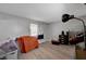 Bedroom featuring modern gray walls, wood flooring, and a window with curtains at 9070 Spring Mountain Rd # 114, Las Vegas, NV 89117