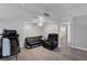 Cozy living room with futon, recliner, ceiling fan, and doorway leading to bathroom at 9070 Spring Mountain Rd # 114, Las Vegas, NV 89117