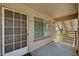 Inviting front porch with large window and door with decorative panes at 9070 Spring Mountain Rd # 114, Las Vegas, NV 89117