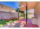 Relaxing backyard features artificial turf, a brick patio and a covered pergola at 9451 Natoma Station Pl, Las Vegas, NV 89123