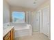 Bright bathroom showcasing a bathtub and a separate glass shower enclosure at 9451 Natoma Station Pl, Las Vegas, NV 89123