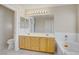 Bathroom featuring wood cabinets, a large mirror, and separate tub with shower at 9451 Natoma Station Pl, Las Vegas, NV 89123