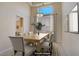 Staged dining room featuring high ceilings, pendant lighting, and large window at 9451 Natoma Station Pl, Las Vegas, NV 89123
