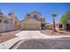 Two-story home featuring desert landscaping, attached garage, and concrete driveway at 9451 Natoma Station Pl, Las Vegas, NV 89123