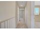 Hallway with white trim and neutral carpeting with access to several rooms at 9451 Natoma Station Pl, Las Vegas, NV 89123