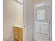 Powder room featuring a sink, cabinet, mirror and a doorway that leads into a laundry room at 9451 Natoma Station Pl, Las Vegas, NV 89123