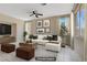 Staged living room featuring tile floors, furniture, and a ceiling fan at 9451 Natoma Station Pl, Las Vegas, NV 89123