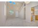 Living room featuring staircase and kitchen at 9451 Natoma Station Pl, Las Vegas, NV 89123