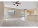 Open floor plan showcasing living and kitchen spaces with sliding glass doors leading to the backyard at 9451 Natoma Station Pl, Las Vegas, NV 89123