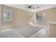 Bright living space featuring neutral paint, tile and carpet flooring, multiple windows, and bar seating at 9451 Natoma Station Pl, Las Vegas, NV 89123