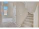 Carpeted staircase featuring neutral paint, a small window and a door leading to the downstairs room at 9451 Natoma Station Pl, Las Vegas, NV 89123