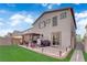 A backyard featuring a lush green lawn, brick patio, and outdoor dining area perfect for gatherings at 1017 Huckburn Ave, Henderson, NV 89015