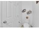 Clean half bathroom with white fixtures, decorative wall shelves, and modern finishes at 1017 Huckburn Ave, Henderson, NV 89015