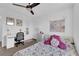 Bright bedroom with floral bedding, a ceiling fan, and a cozy, inviting atmosphere at 1017 Huckburn Ave, Henderson, NV 89015