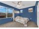 Comfortable bedroom with large windows offering natural light and a ceiling fan at 1017 Huckburn Ave, Henderson, NV 89015