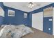 Cozy bedroom with blue walls, a ceiling fan, and a closet for ample storage space at 1017 Huckburn Ave, Henderson, NV 89015