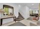 Entrance hall features tiled flooring, stairs, and a console table, creating a welcoming space at 1017 Huckburn Ave, Henderson, NV 89015