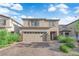 Charming two-story home with a two-car garage and brick paved driveway at 1017 Huckburn Ave, Henderson, NV 89015