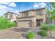 Attractive home featuring a two-car garage, brick paved driveway, and landscaped front yard at 1017 Huckburn Ave, Henderson, NV 89015