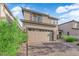 Charming two-story home with a two-car garage and brick paved driveway at 1017 Huckburn Ave, Henderson, NV 89015