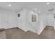 Bright hallway with neutral decor, multiple doors, and a staircase with railing at 1017 Huckburn Ave, Henderson, NV 89015