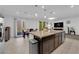 Kitchen island with seating offers backyard views and connects to the dining and living areas at 1017 Huckburn Ave, Henderson, NV 89015