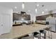 Bright kitchen features an island with bar seating, stainless steel appliances, and dark wood cabinetry at 1017 Huckburn Ave, Henderson, NV 89015