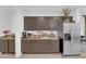 Kitchen area featuring stainless steel refrigerator and coordinated brown cabinetry at 1017 Huckburn Ave, Henderson, NV 89015