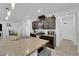 Open kitchen with a large island featuring a sink, modern faucet, and stainless steel appliances at 1017 Huckburn Ave, Henderson, NV 89015