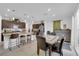 Open-concept kitchen and dining area with modern appliances and pendant lighting at 1017 Huckburn Ave, Henderson, NV 89015