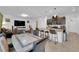Spacious kitchen, dining and living area with a breakfast bar and a large television at 1017 Huckburn Ave, Henderson, NV 89015