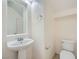Modern powder room features a pedestal sink and tiled floors at 10428 Mulvaney Cir, Las Vegas, NV 89141