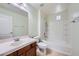 Clean bathroom featuring a combined tub and shower with white tile and a vanity with sink at 10428 Mulvaney Cir, Las Vegas, NV 89141