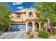 Lovely two-story home featuring desert landscaping and a covered entry with decorative arches at 10428 Mulvaney Cir, Las Vegas, NV 89141